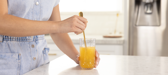 person mixing collagen drink