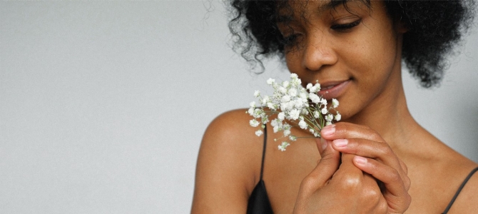 woman-in-black-tank-top-holding-baby-s-breath-flowers- by Anna Shvets women smelling baby's breath flowers