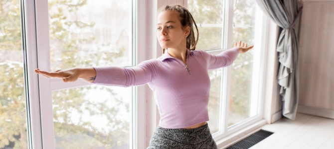 woman-doing-a-yoga-pose- by Alexy Almond woman doing yoga in her home