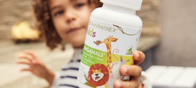 Child holding a bottle of Pharmanex Kids Jungamals by Nu Skin