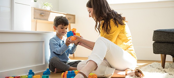 mom playing legos with son