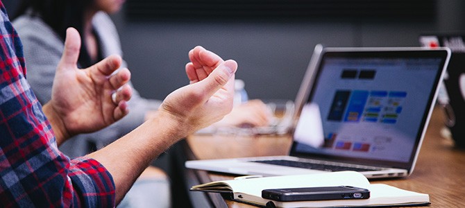 man speaking with his hands during a meeting - photo by Headway on Unsplash